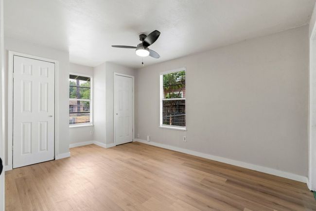 High ceilings, multiple windows, and two walk-in closets in this bedroom. | Image 13
