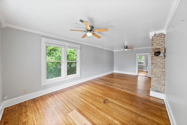 Unfurnished room featuring ceiling fan, hardwood / wood-style flooring, baseboards, and ornamental molding | Image 6