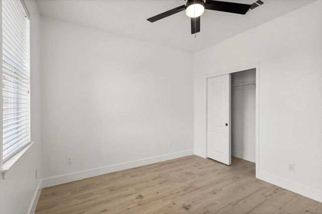 Unfurnished bedroom featuring light wood-type flooring, a closet, and ceiling fan | Image 23