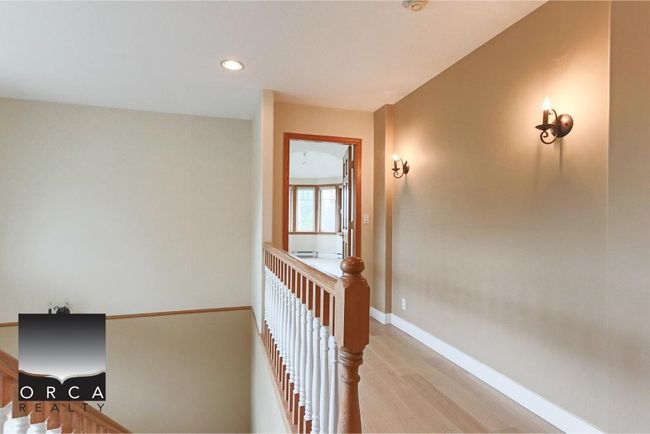 Corridor with light wood-type flooring, recessed lighting, and an upstairs landing | Image 21