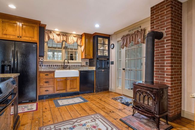 beautiful open concept kitchen with wood stove | Image 16