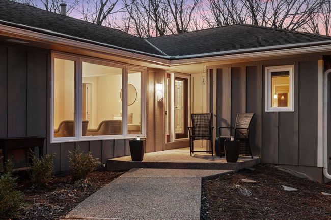 Pebbled entry way surrounded by beautiful landscaping | Image 6