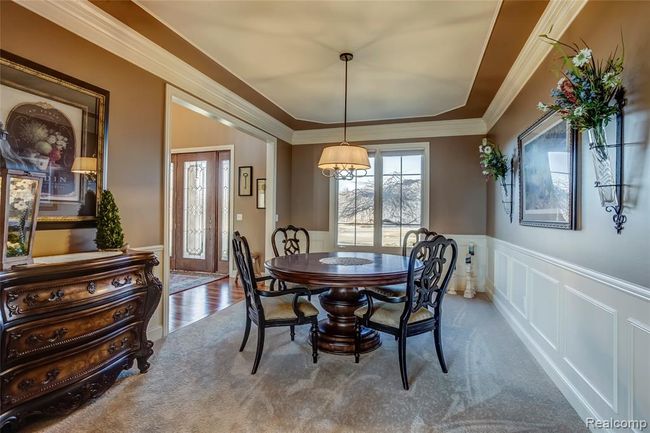 Formal dining room with beautiful wainscotting and crown molding | Image 10