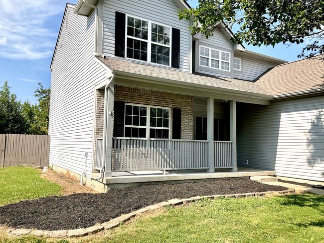 Front of house with large shade tree and covered porch | Image 4