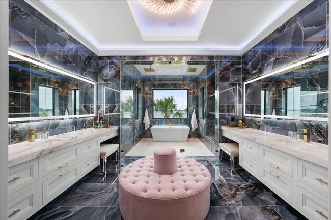 Bathroom with a sink, two vanities, tile walls, and a shower stall | Image 16