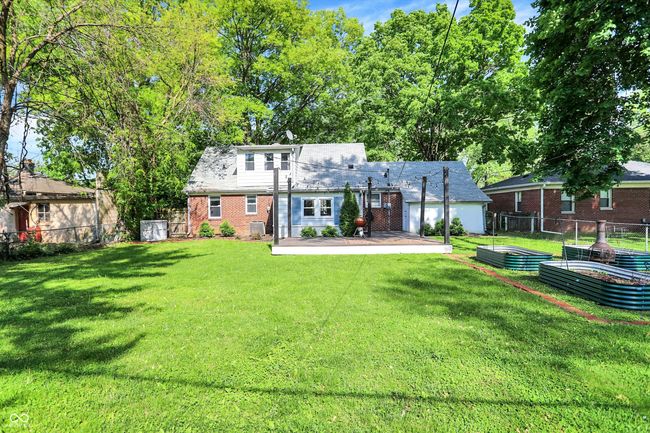 back of house with a vegetable garden, brick siding, and a patio area | Image 43