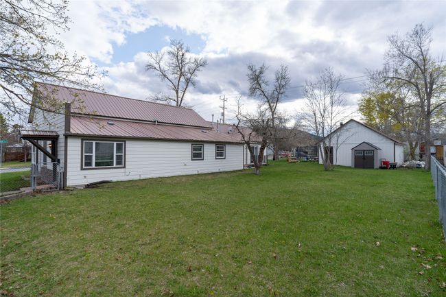View of yard with fence, an outdoor structure, and a shed | Image 42