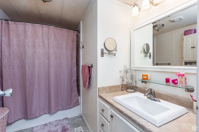 Bathroom featuring visible vents, shower / tub combo with curtain, and vanity | Image 14