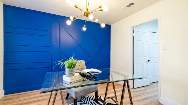 Office space with visible vents, light wood-type flooring, and a notable chandelier | Image 18
