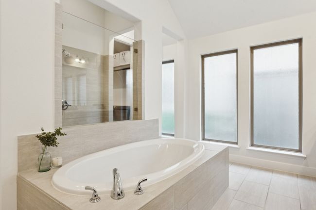 Bathroom with a garden tub, vaulted ceiling, and tile patterned floors | Image 20