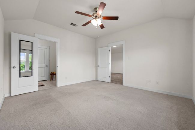 Spacious primary with a ceiling fan. | Image 13