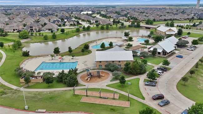 Aerial view of residential area with a pool area and a large body of water | Image 26