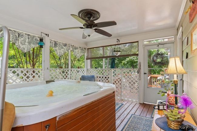 Sunroom / solarium featuring a ceiling fan and a jacuzzi | Image 38