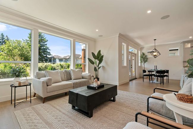 Living area featuring light wood finished floors, healthy amount of natural light, and recessed lighting | Image 13