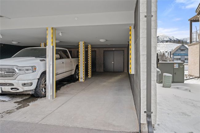 Garage featuring a mountain view and a carport | Image 34