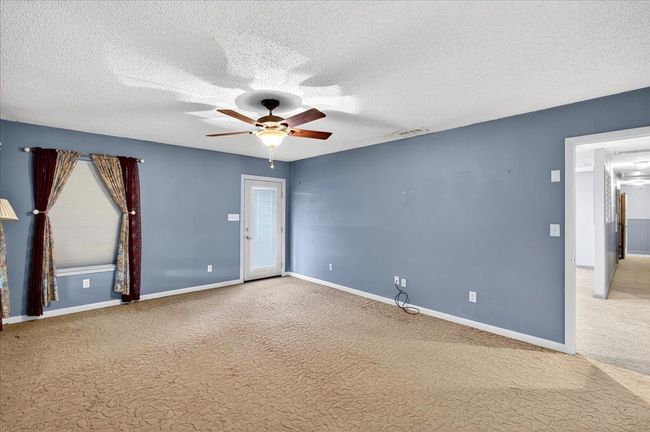 Spare room with carpet, a ceiling fan, and a textured ceiling | Image 23