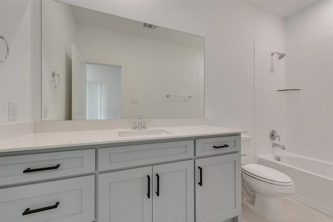 Full bath with vanity, toilet, tub / shower combination, and tile patterned flooring | Image 6