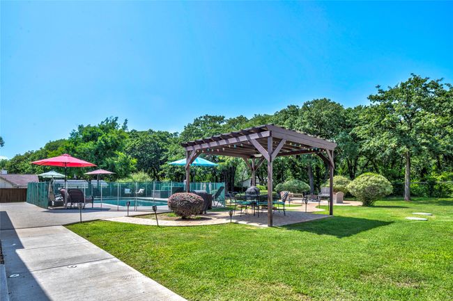 Pergola, rubber surfacing around pool, and custom pool fence | Image 32