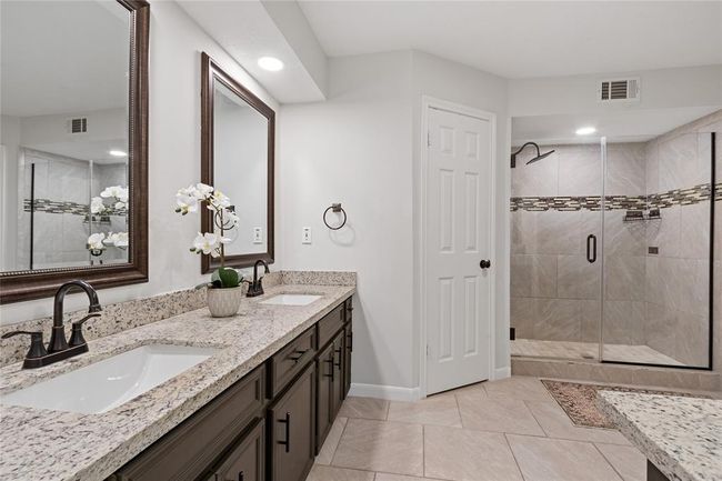 Primary bath features 2 walk in closets, large shower, dual sinks and separate vanity area. | Image 27