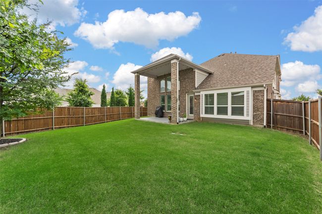 Rear view of house featuring brick siding, a patio area, and a shingled roof | Image 38
