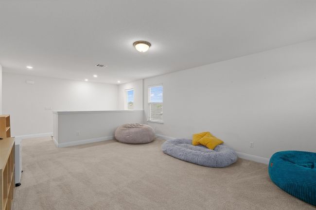 Living area featuring light carpet, recessed lighting, and an upstairs landing | Image 15