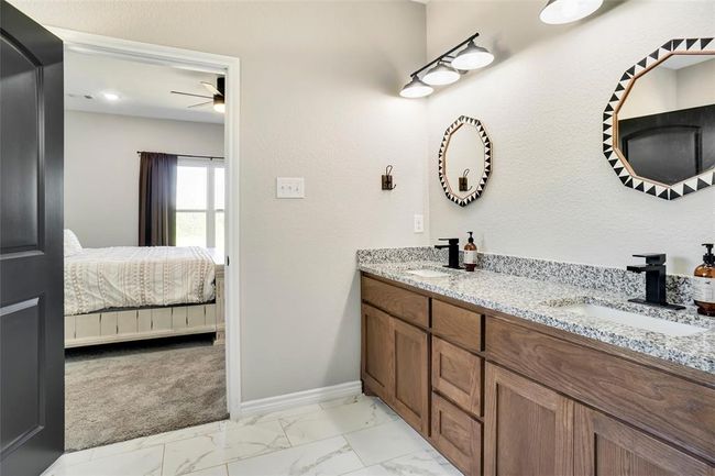 Bathroom with tile floors, ceiling fan, and dual bowl vanity | Image 24