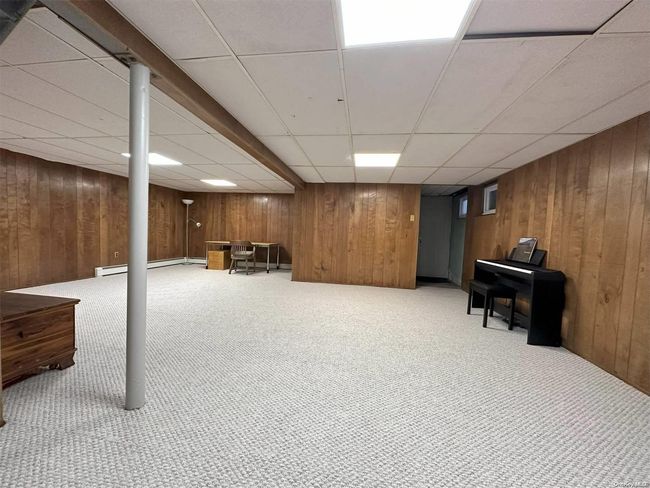 Basement has an outside entrance to garage and back yard | Image 19