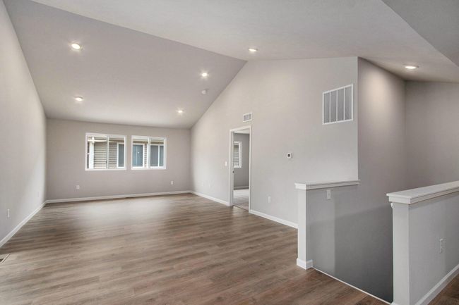 The open concept floorplan has full sight lines into the great room. There is an abundance of natural lighting from windows and is further enhanced by the vaulted ceilings and recessed lighting. | Image 7