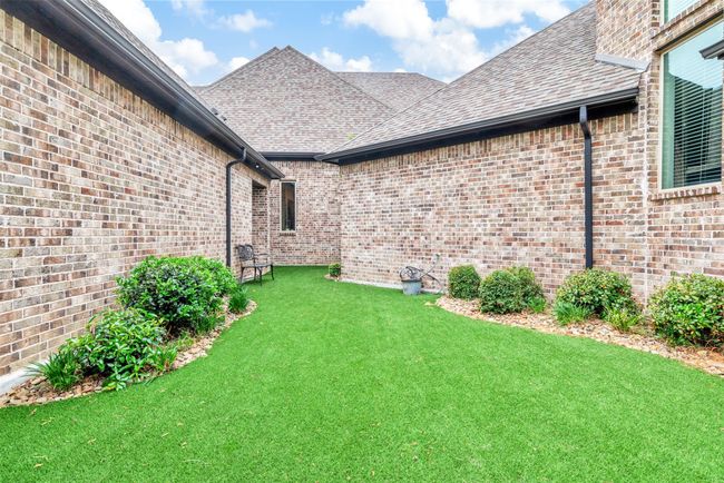 This handy side yard is a great dog run with a pet door, easy to clean artificial turf and stone gardens. A nice secure place for kids to play as well! | Image 34