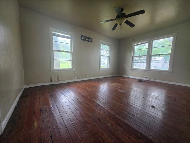Spare room with hardwood / wood-style floors, plenty of natural light, ceiling fan, and baseboards | Image 7