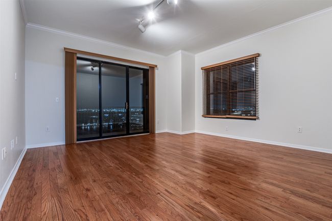 Open floor plan is perfect for entertaining with incredible views, neutral colored paint, crown molding, and window coverings. Taller ceilings give this 2/2 condo a more expansive feel. | Image 16