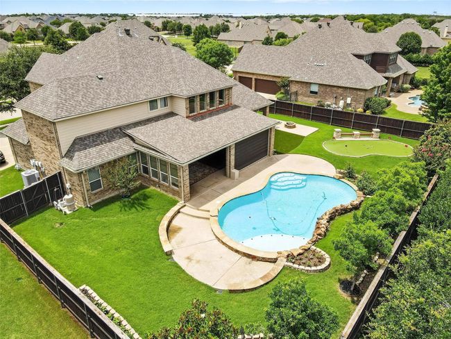 View of pool with a fenced backyard, a patio, a putting green, and a residential view | Image 38