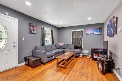 Living room featuring a textured ceiling and hardwood / wood-style flooring | Image 3