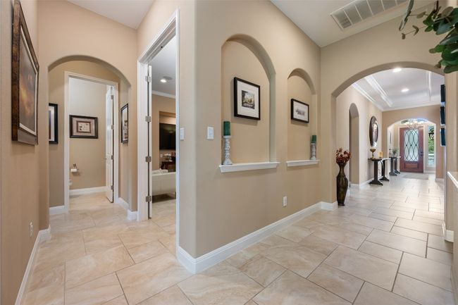Hall featuring crown molding, recessed lighting, and arched walkways | Image 23
