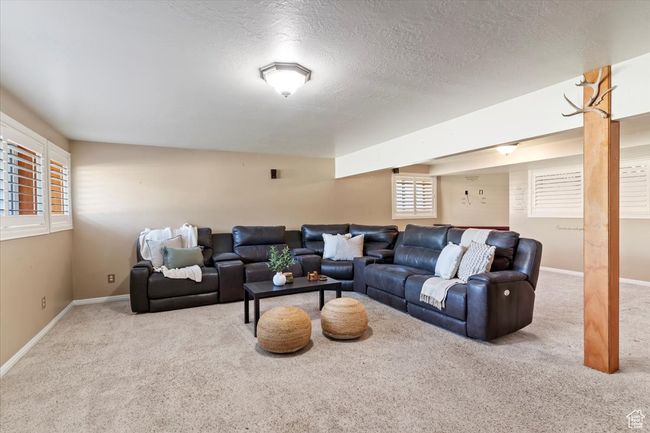 Carpeted living area with baseboards and a textured ceiling | Image 14