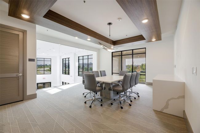 Carpeted dining room featuring a wealth of natural light and a raised ceiling | Image 22