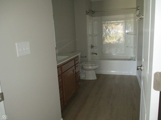 full bathroom with vanity, toilet, shower / bathtub combination, and wood finished floors | Image 15