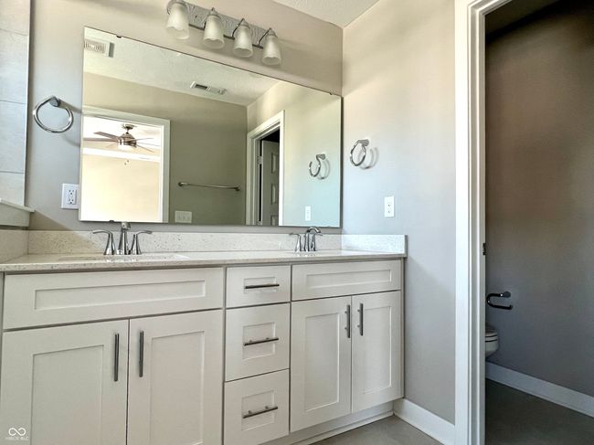 Primary en-suite bathroom with large shower with seating, double vanity & separate water closet | Image 42