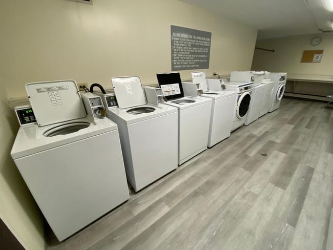 Both laundry rooms equipped with many washers and dryers! | Image 15