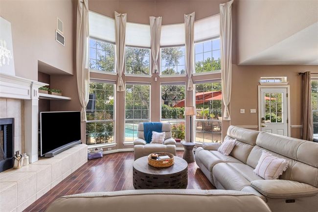 Natural lighting and hardwood floors through out the main level of the home. | Image 12