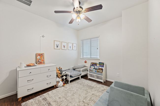 Bedroom with baseboards, dark wood-style floors, and ceiling fan | Image 27