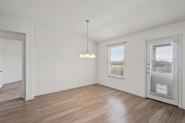 The adjoining dining area makes everyday meals easy and keeps the kitchen connected to the heart of the home and a view of the green out back. | Image 9