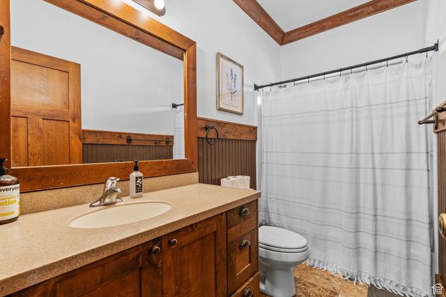 Bathroom featuring vanity, crown molding, and toilet | Image 27