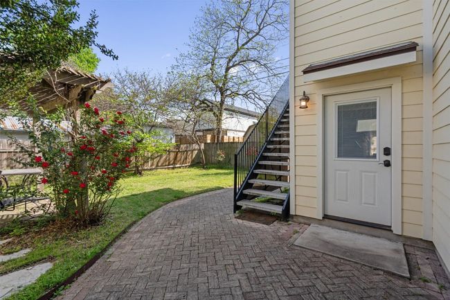 Entrance to property with a patio, fence, and a lawn | Image 24