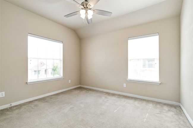 Spare room featuring light carpet, baseboards, and a ceiling fan | Image 33