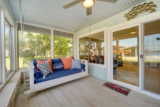 Sunroom featuring healthy amount of natural light and a ceiling fan | Image 28