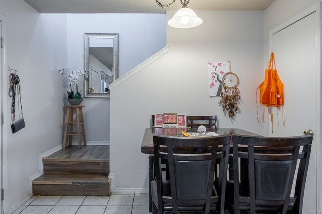 Dining area with tile patterned floors, baseboards, and stairway | Image 21