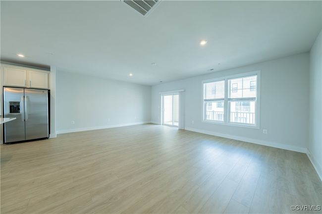 Unfurnished living room featuring light wood-style flooring, recessed lighting, and baseboards | Image 9