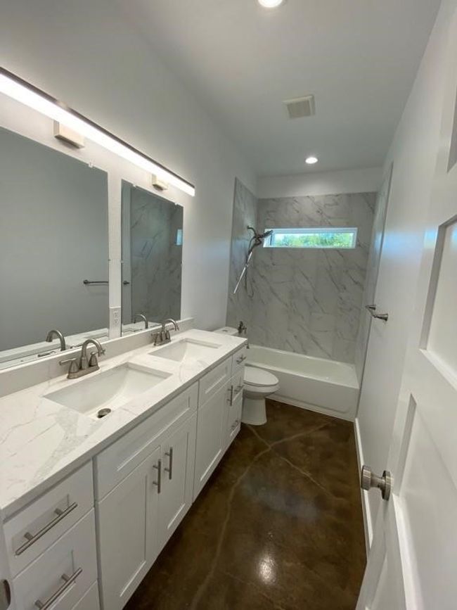 Bathroom featuring double vanity, toilet, shower / bathtub combination, and recessed lighting | Image 18