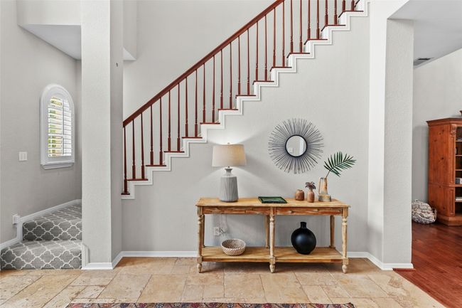 Stairway with stone tile floors and baseboards | Image 9